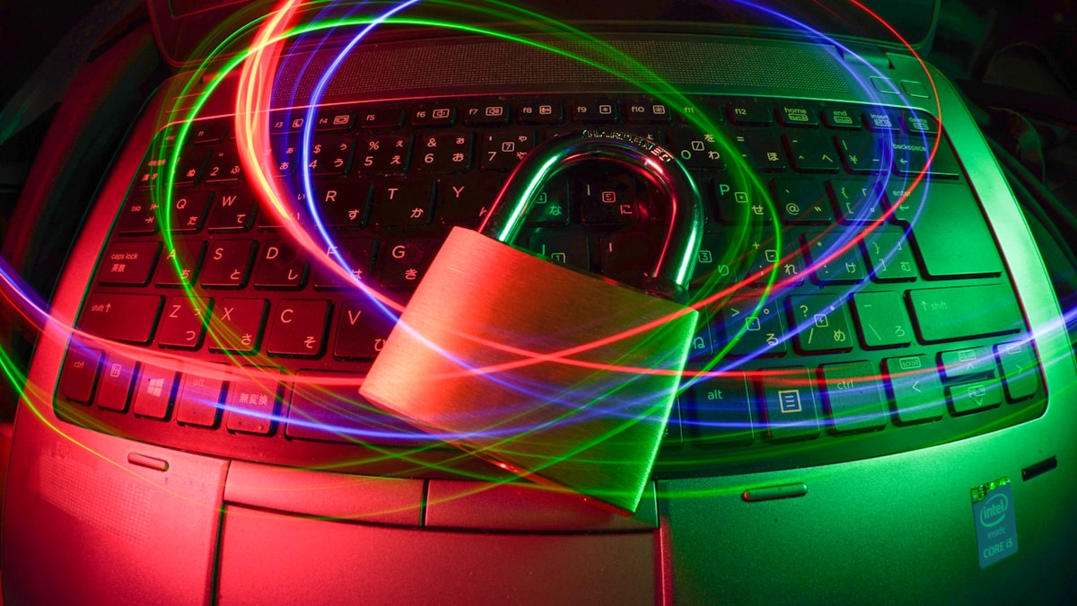 A padlock resting on a laptop keyboard with colorful light trails in the background, representing data access security for AI agents