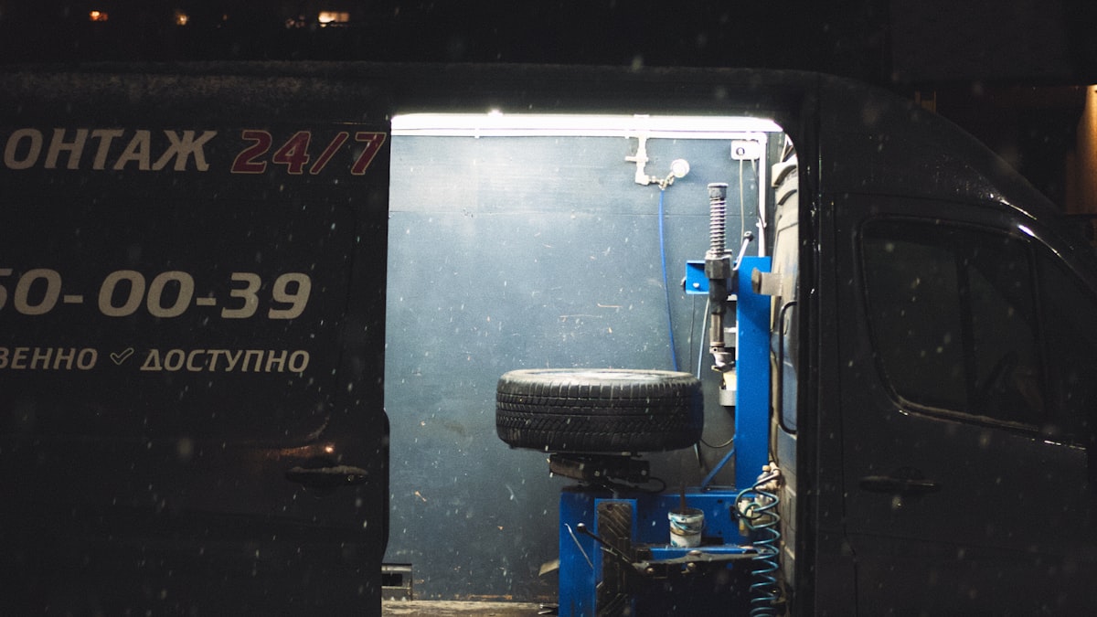 A service van illuminated at night, representing an after-hours home service call in progress