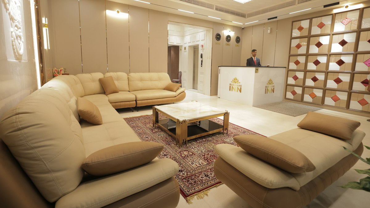 A modern hotel lobby with a reception desk and seating area