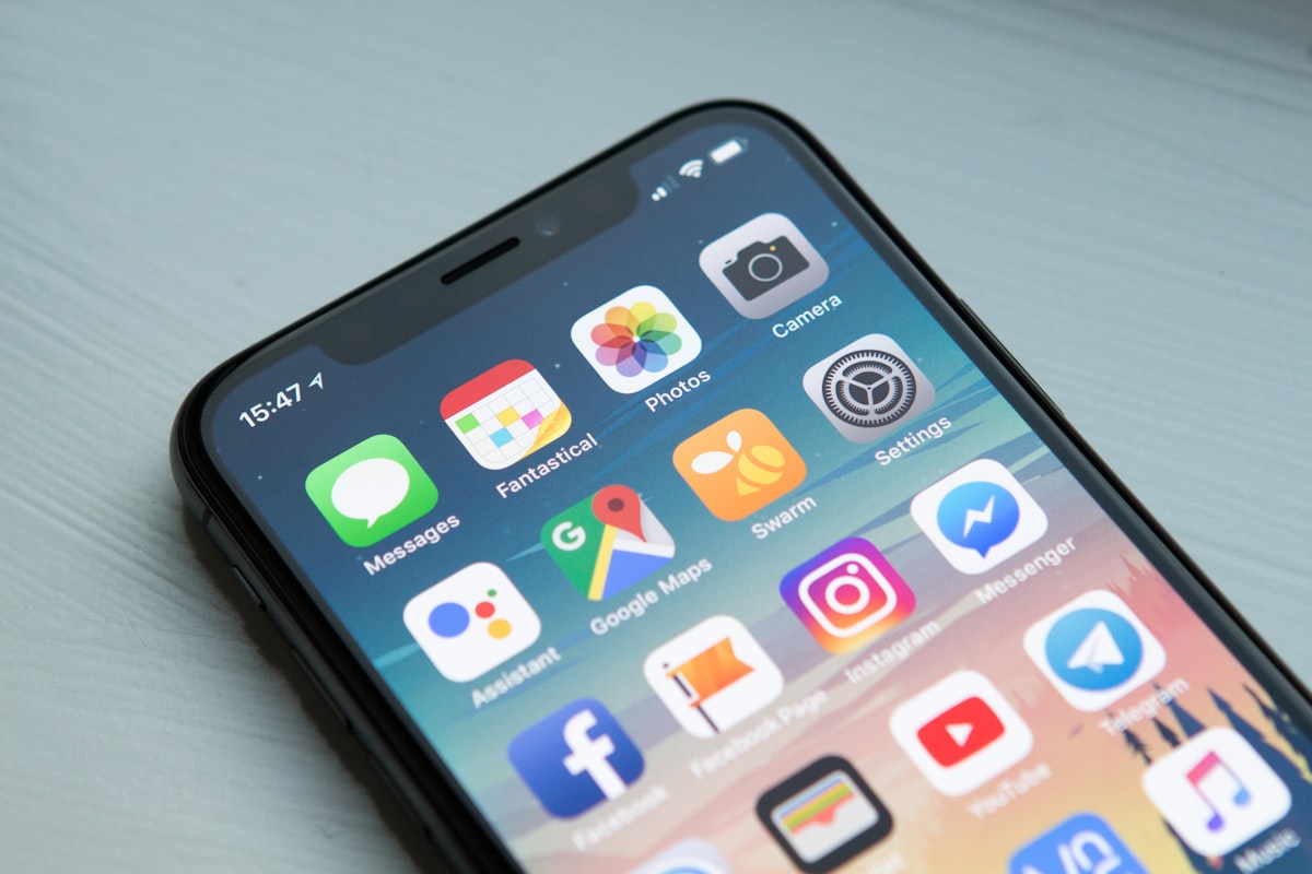 iPhone screen showing colorful app icons on the App Store home screen, representing app store optimization and mobile app discoverability