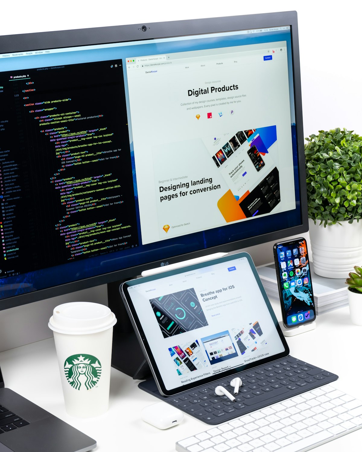 Web designer working on a laptop with design wireframes and code on screen, representing web development services for Kansas City small businesses